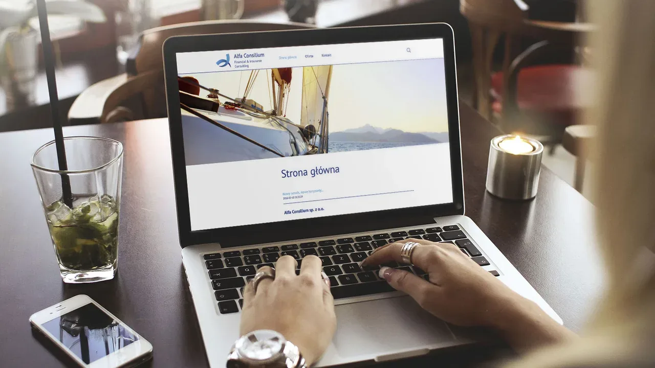 Alfa Consilium website displayed on laptop in a café